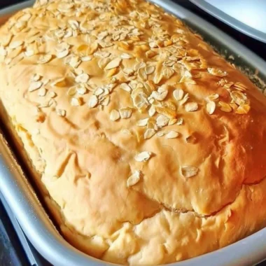 Freshly baked honey oat bread cooling on a rack