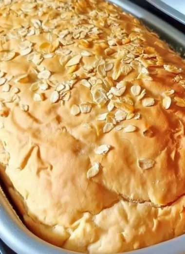 Freshly baked honey oat bread cooling on a rack