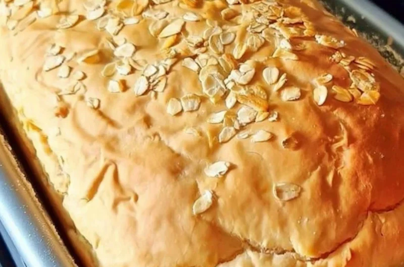 Freshly baked honey oat bread cooling on a rack