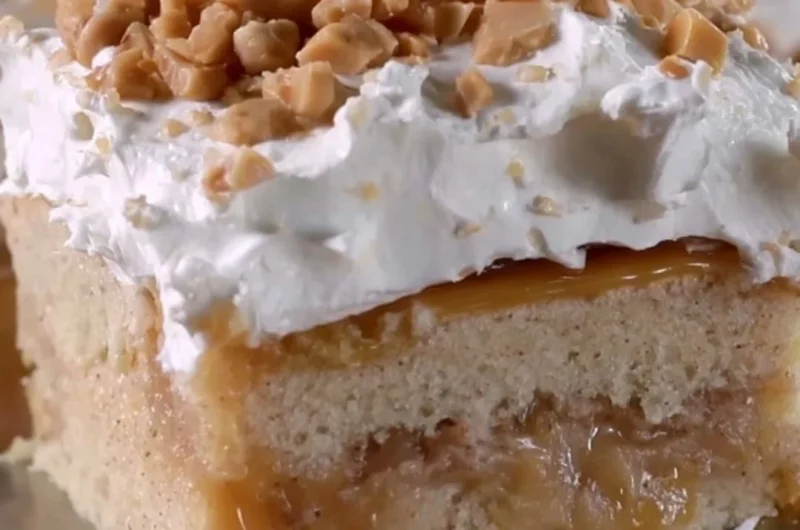 Delicious caramel apple poke cake topped with creamy caramel sauce and apple slices