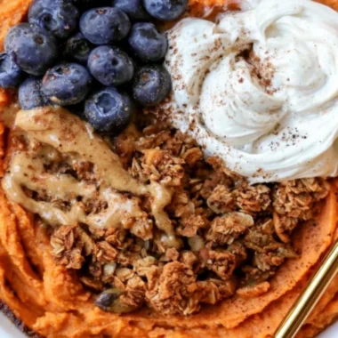 Fluffy sweet potato breakfast bowl topped with fruits and nuts for a nutritious meal.